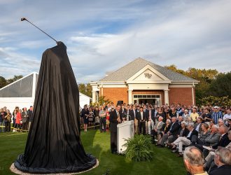 The Arnold Palmer statue stands fully covered in black fabric moments before its unveiling at Wake Forest University